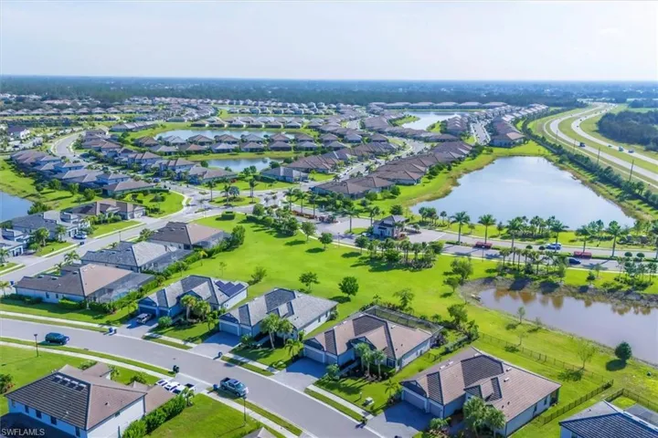 Aerial view of residential area featuring a large body of water
