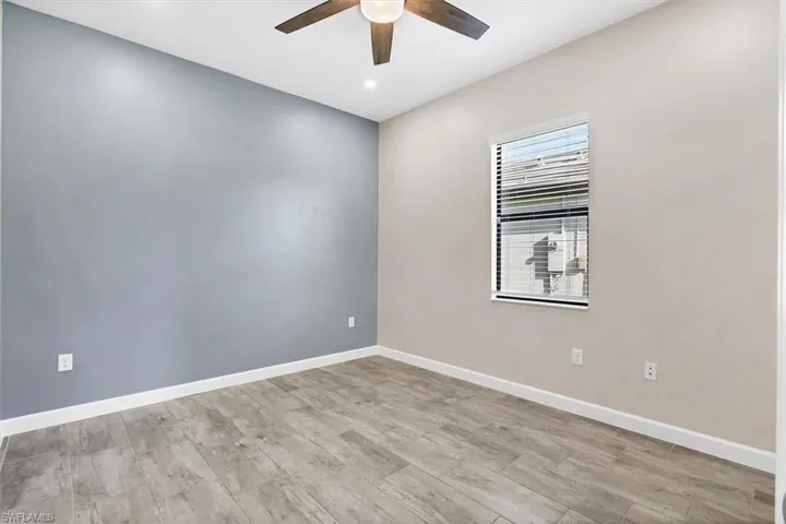 Spare room featuring a ceiling fan and light wood finished floors