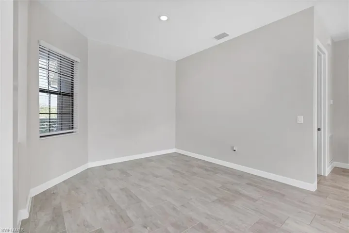 Spare room featuring light wood-type flooring and recessed lighting
