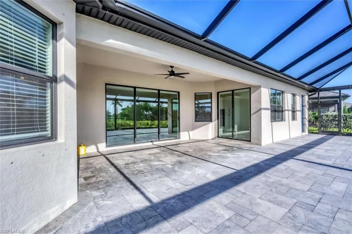 View of patio / terrace featuring ceiling fan and a lanai