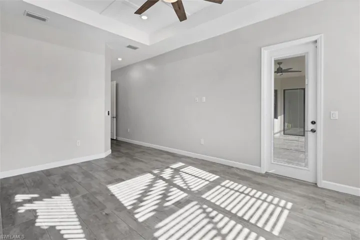 Empty room with a ceiling fan, recessed lighting, and wood finished floors