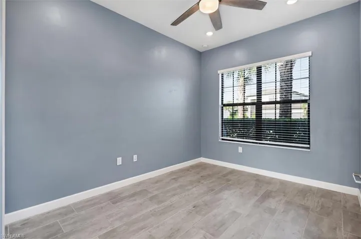 Spare room with ceiling fan, recessed lighting, and wood finished floors