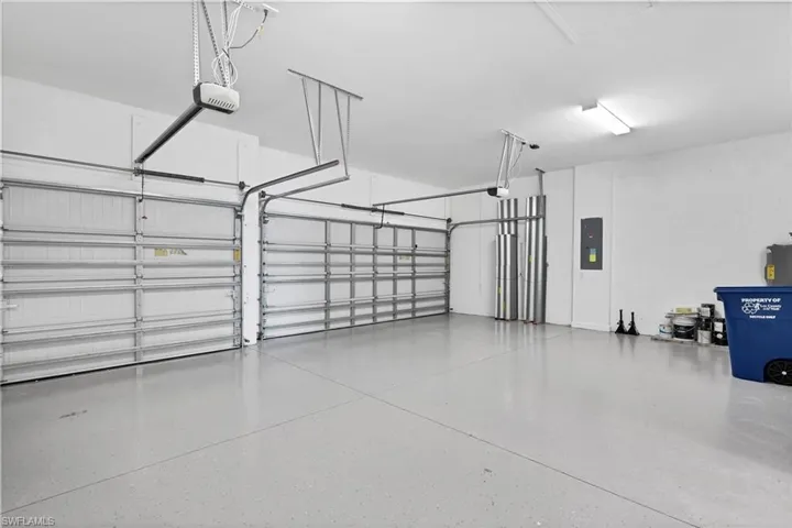 Garage with electric panel and a garage door opener