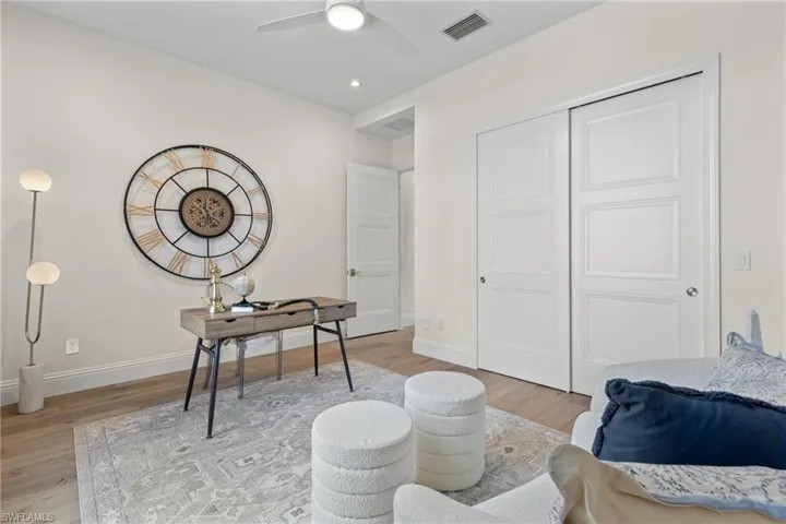 Fifth bedroom or den/office featuring light wood-type flooring and ceiling fan