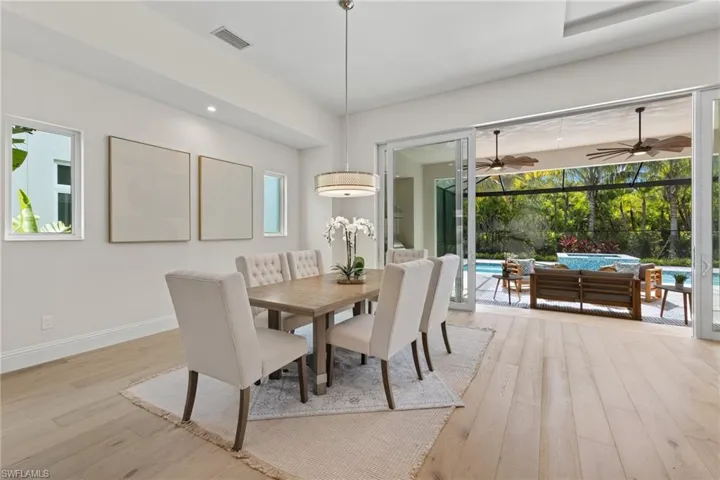 Dining space featuring ceiling fan and light hardwood / wood-style flooring
