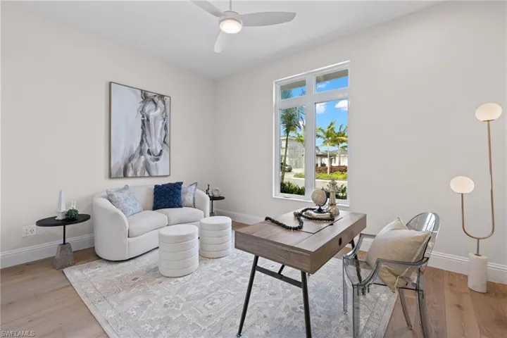Fifth bedroom or den/office featuring ceiling fan and light hardwood / wood-style flooring