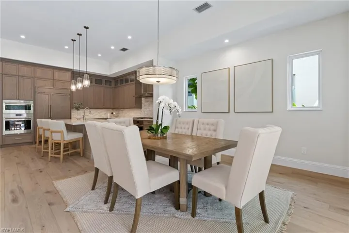 Great Dining space featuring a great chandelier, brilliant sunlight, recessed lighting and light wood-type flooring