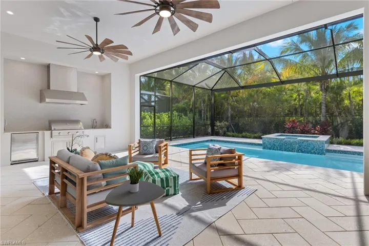 Privacy abounds- View of pool featuring ceiling fan, an in ground hot tub, a patio, outdoor lounge area, and picture frame enclosure