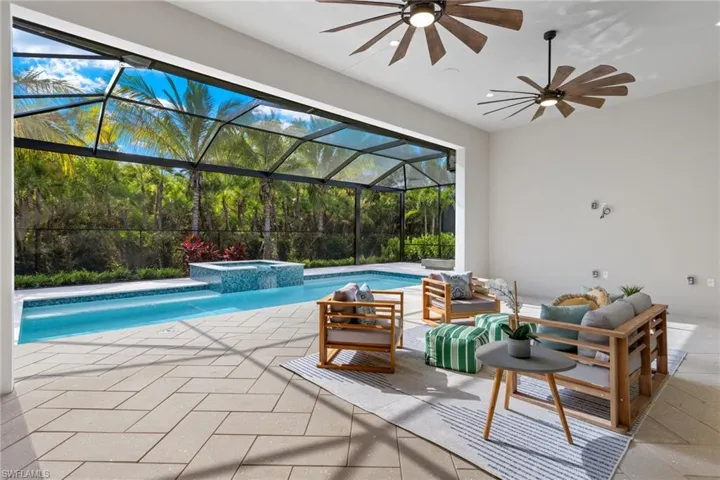 View of swimming pool featuring a patio area, an outdoor hangout area, an in ground hot tub, picture frame enclosure, and ceiling fan