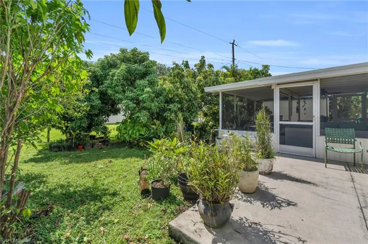 View of yard featuring a sunroom and a patio area