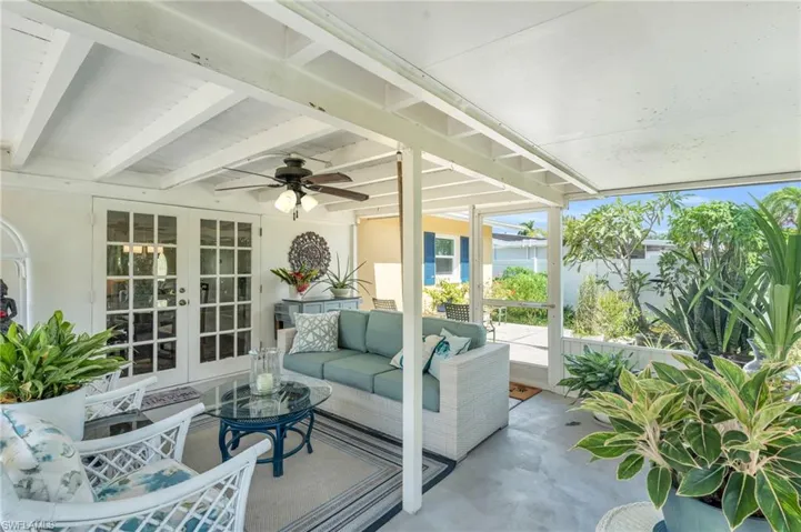Sunroom / solarium with french doors and ceiling fan