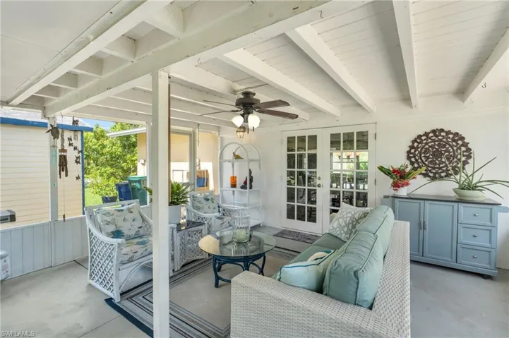 Sunroom with french doors, beam ceiling, ceiling fan, and a wealth of natural light