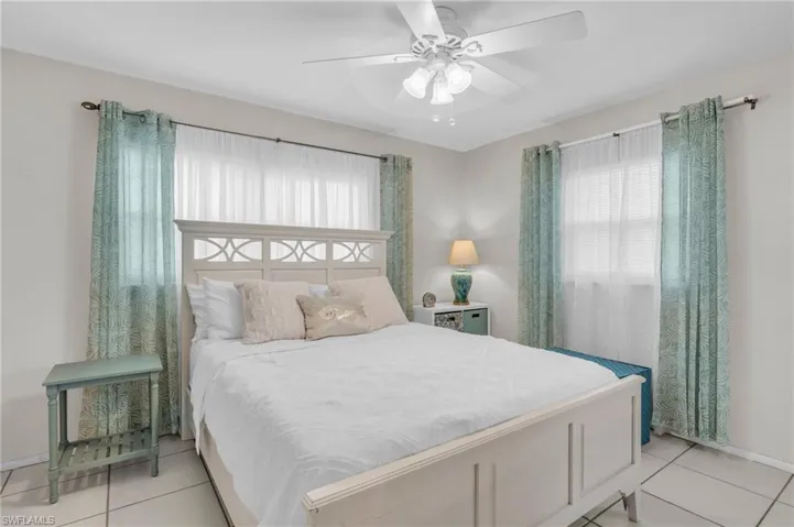 Tiled bedroom with ceiling fan