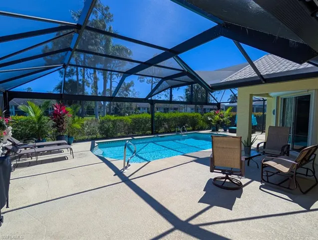 Pool with a lanai and a patio area