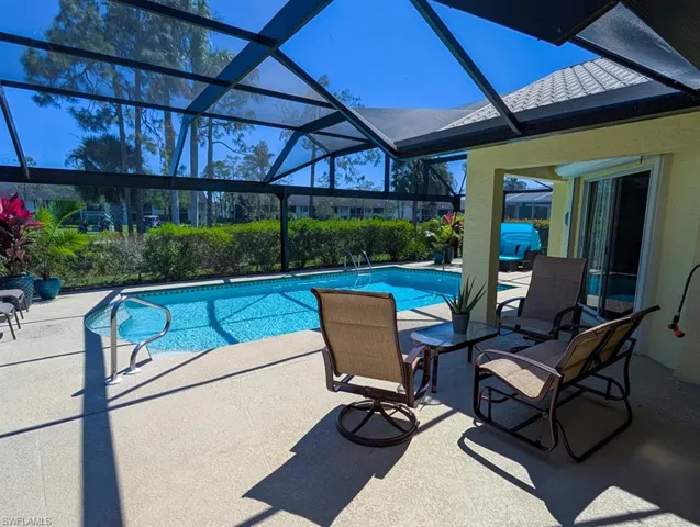 Outdoor pool with a patio and a lanai
