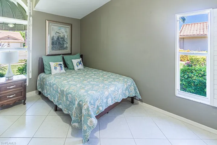 Tiled bedroom featuring baseboards