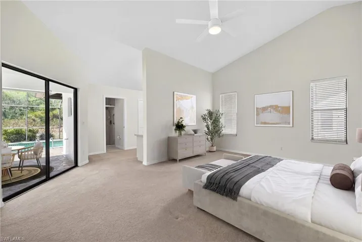 Bedroom featuring lofted ceiling, light carpet, access to outside, and ceiling fan