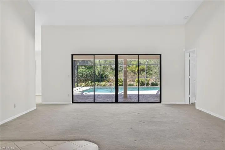 Spare room with light colored carpet and a high ceiling