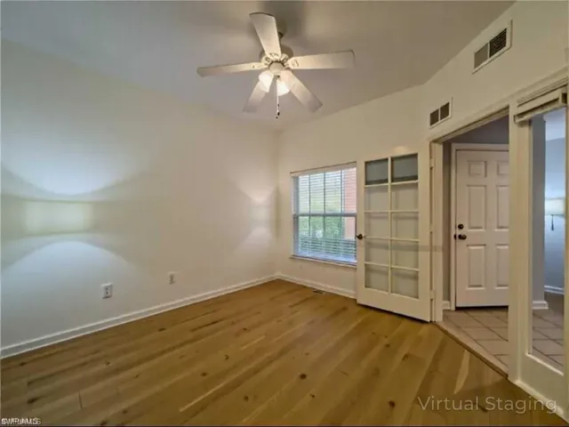 Spare room with visible vents, baseboards, and wood finished floors