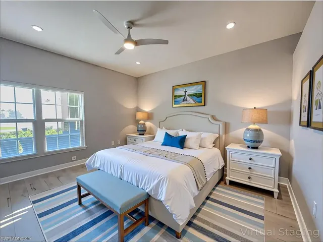 Bedroom with baseboards, wood finished floors, and recessed lighting