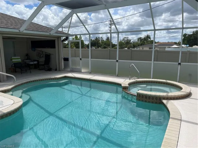 View of pool featuring a patio, an in ground hot tub, and a lanai