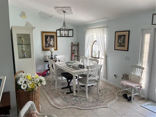 Dining space featuring light tile patterned floors
