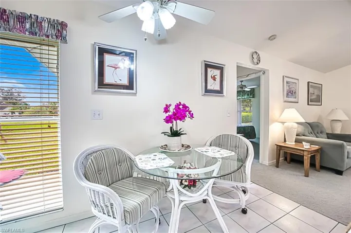Tile dining room with ceiling fan