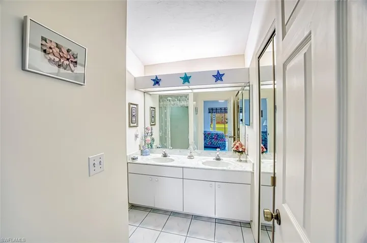 Bathroom with tile patterned flooring and vanity