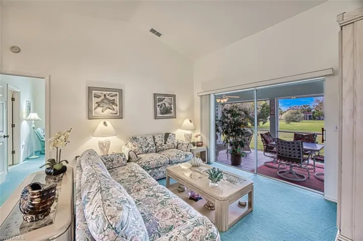 Living room opens to covered sunroom lanaii