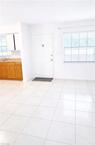 Foyer featuring light tile patterned flooring and a textured ceiling