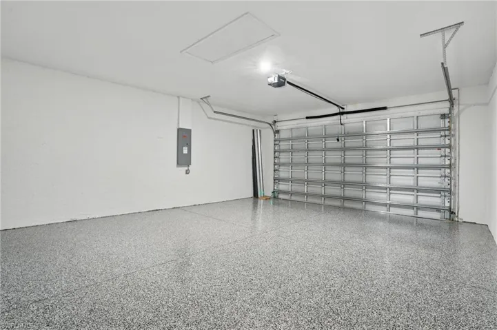 Garage with a garage door opener and electric panel