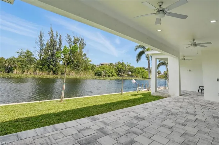 View of patio / terrace with a ceiling fan and a water view