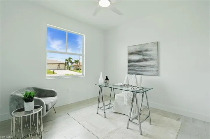 Home office featuring a ceiling fan, wood finished floors, and baseboards