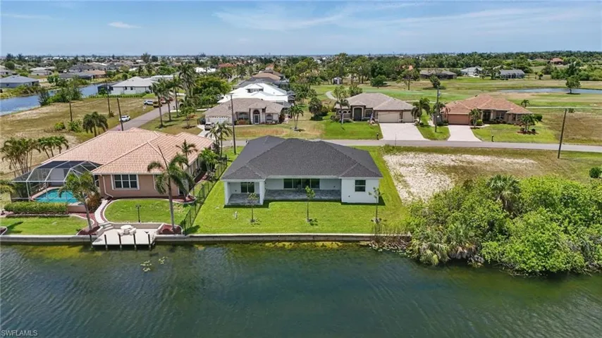 Aerial perspective of suburban area with a large body of water