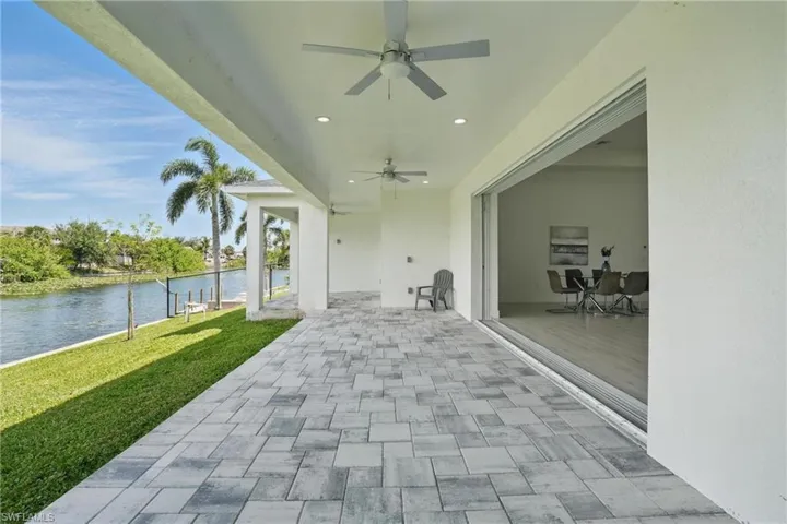 View of patio / terrace featuring a water view and a ceiling fan