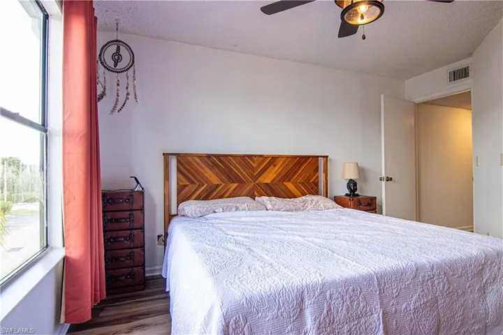 Bedroom featuring wood finished floors, ceiling fan, and a textured ceiling