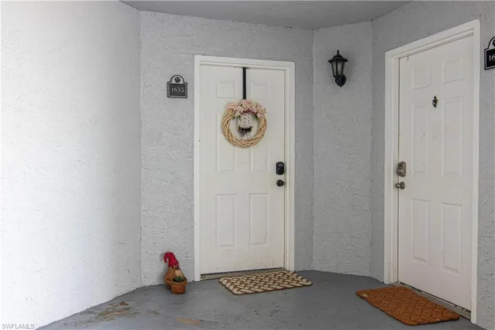 Doorway to property with stucco siding