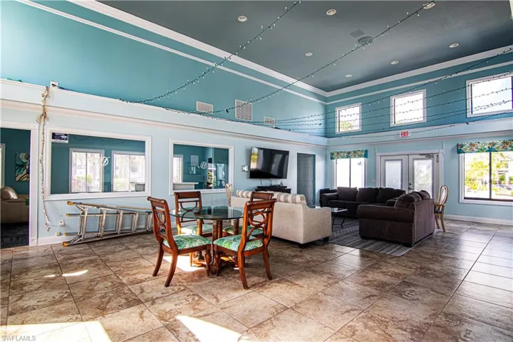 Community lobby featuring a high ceiling, crown molding, and recessed lighting