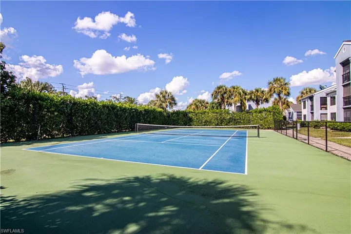 View of tennis court featuring community basketball court
