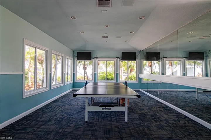 Playroom with healthy amount of natural light, recessed lighting, and lofted ceiling