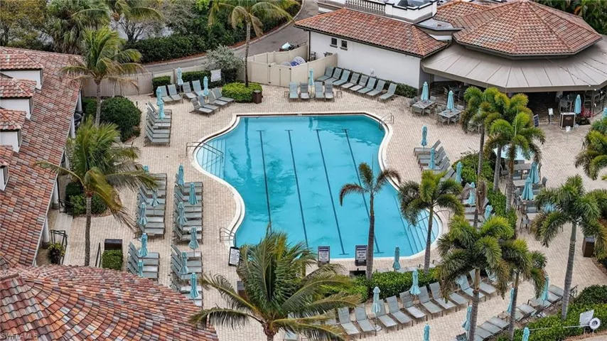Community pool with a patio Tiki Bar an Grill
