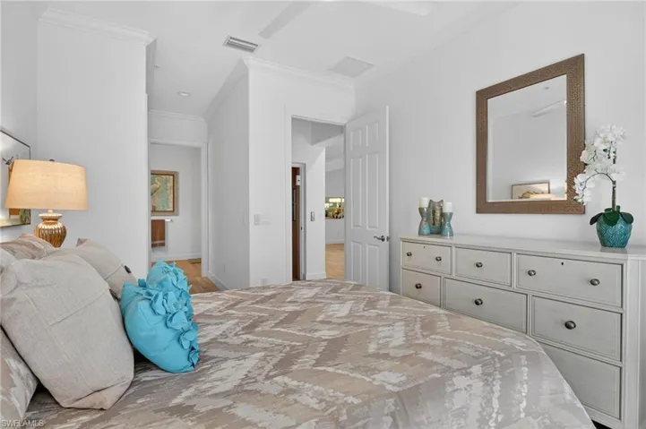 Bedroom with ornamental molding and ceiling fan