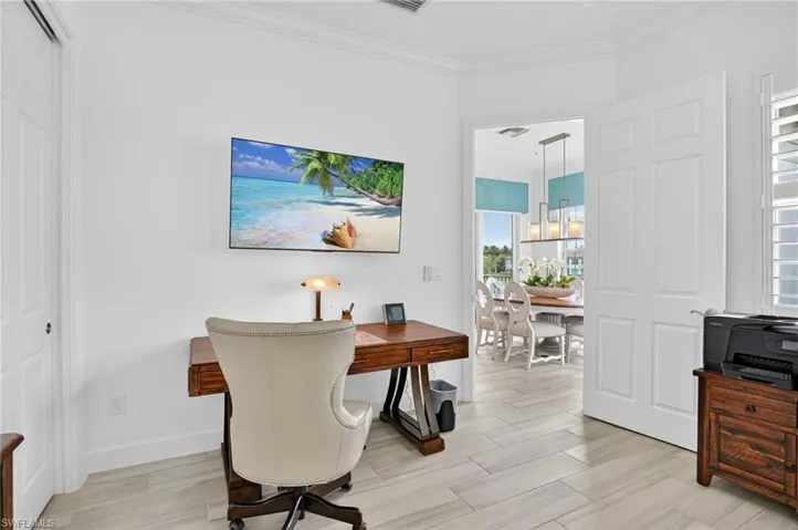 Den/Office space featuring ornamental molding and wood-look floors