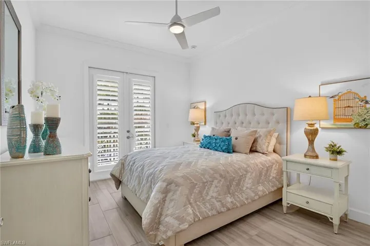 Bedroom with wood-look tiled floors, crown molding, ceiling fan, access to exterior, French Glass doors with a retractable screen