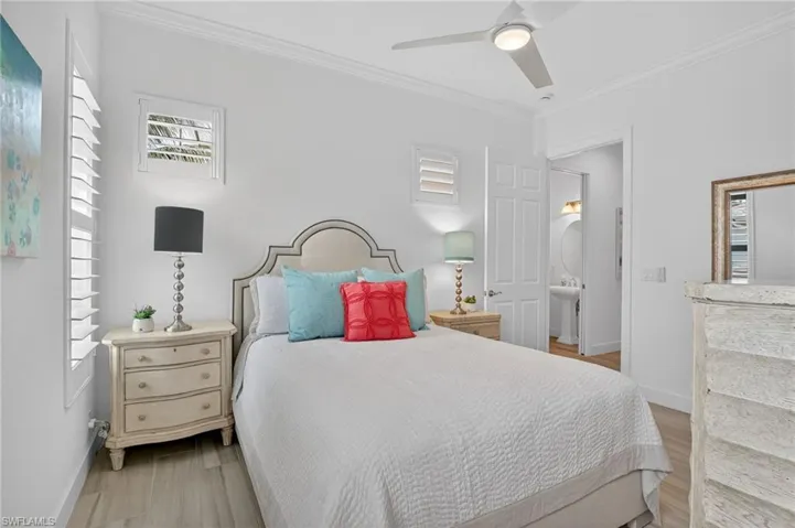 Bedroom with ornamental molding, ceiling fan, and light tile floors