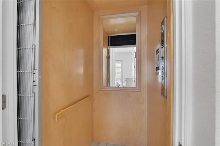Private Elevator with upgraded cherry wood interior, 4 LED lights, scissor gate, wood like plank tile floor