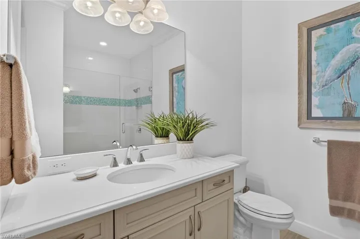 Full Guest Quarters bath featuring vanity, a stall shower, and crown molding