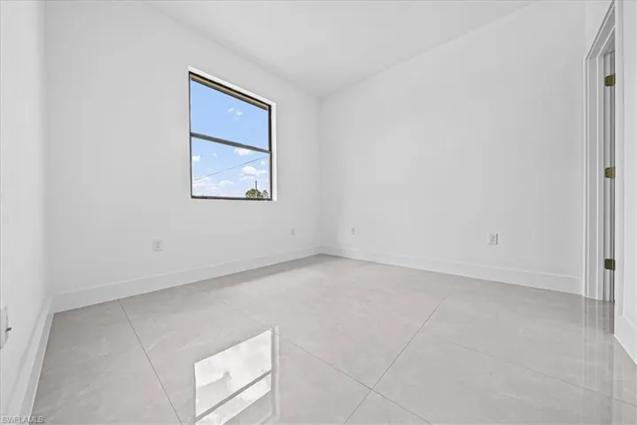 Empty room featuring baseboards