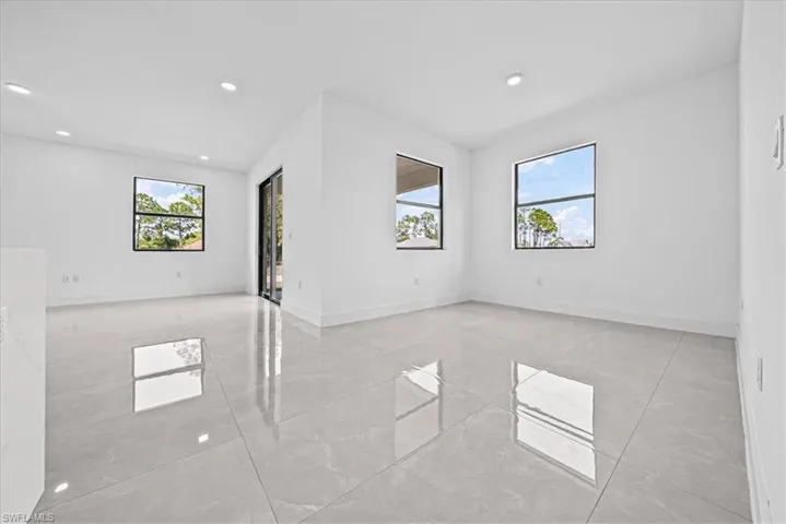Spare room with baseboards and recessed lighting