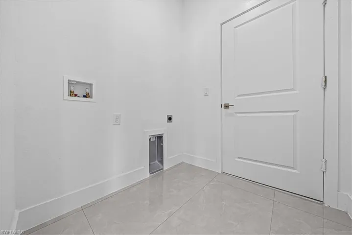 Laundry area featuring hookup for a washing machine, electric dryer hookup, and a fireplace